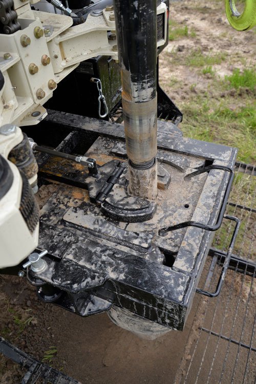 Tripping out is fast with air-powered holding fork and hydraulically-operated, adjustable breakout wrench on the water well drill rigs.